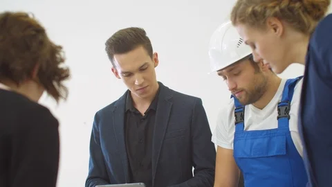 Gruop of engineers work on proect of houses with builder in helmet Stock Footage 121813220