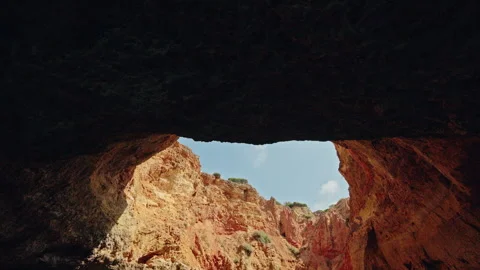Gruta do Paraiso toward sunlit golden limestone cliffs Stock Footage 340921237