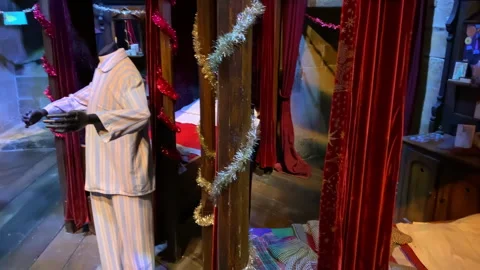 Gryffindor boys' dormitory set with beds and pyjamas in the Harry Potter Studio Stock Footage 323918461