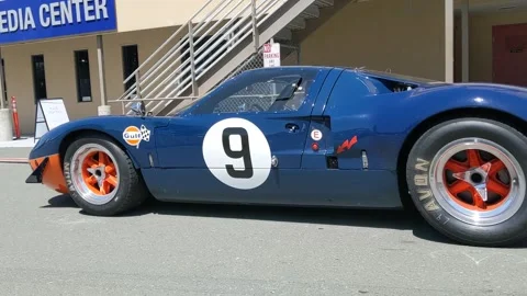 Gt40 rolls through paddock Stock Footage 149899374