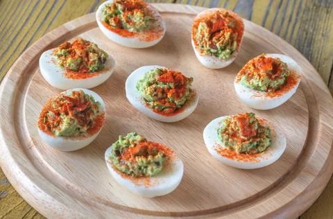 Guacamole and bacon deviled eggs Stock Photos