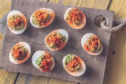 Guacamole and bacon deviled eggs Stock Photos
