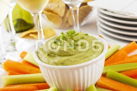 Guacamole with carrot and celery sticks Stock Photos
