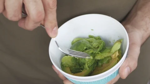 Guacamole dip sandwiches making, squeezing avocado using kitchen fork Video stock 101980133