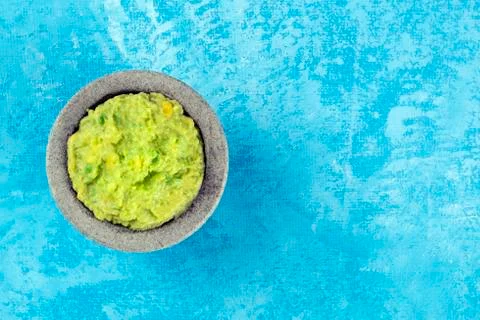 Guacamole in a molcajete, Mexican avocado dip in the typical stone mortar, top Stock Photos