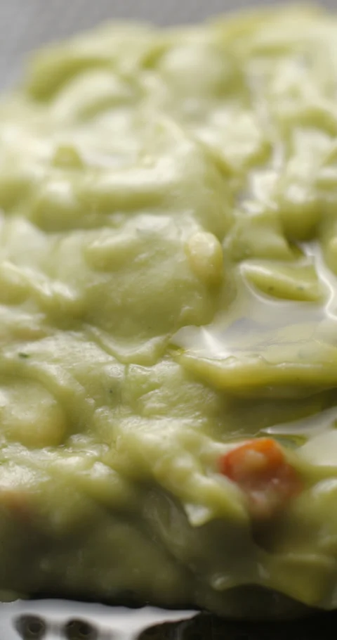 Guacamole rotating close up slowmotion, vertical view Stock Footage 280520549