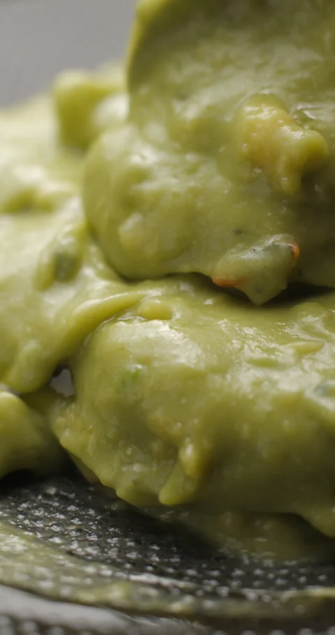 Guacamole rotating close up slowmotion, vertical view Stock Footage 280520574