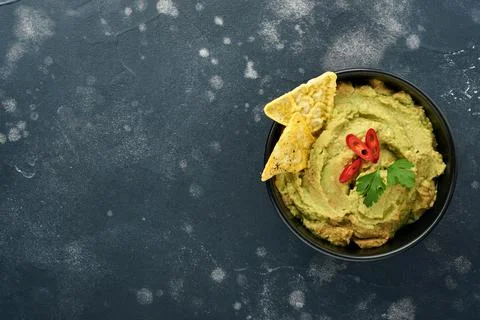 Guacamole. Traditional latinamerican Mexican dip sauce in a black bowl with a Stock Photos