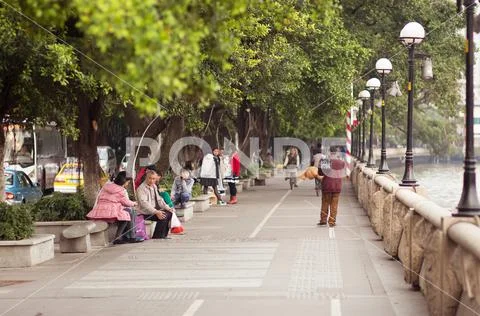 Guangzhou, China - MARCH 15, 2016: People walk at embankment of Zhujiang River Stock Photos