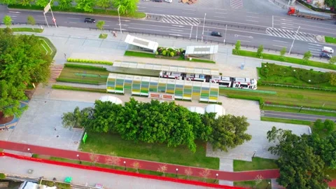 Guangzhou tram station canopy beside grass covered tracks in China Stock Footage 346032553