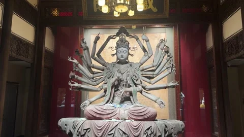 Guanyin statue with multiple arms in a temple. Video stock 341577150