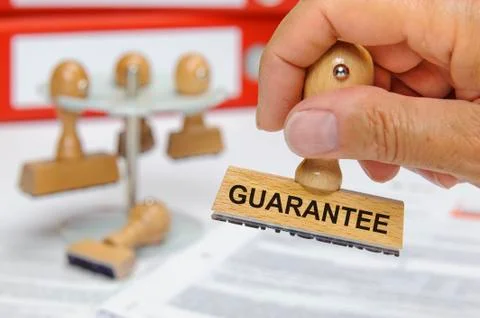 Guarantee printed on rubber stamp Stock Photos
