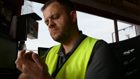Guard bites his nails at workplace. Handsome security guard in surveillance room Video stock 108541084
