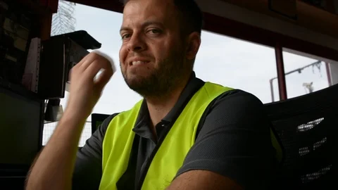 Guard bites his nails at workplace. Handsome security guard in surveillance room Stock Footage 108541140