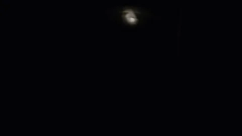 The Guard Inspects the Territory of the Beach with a Flashlight. Stock Footage 202843499