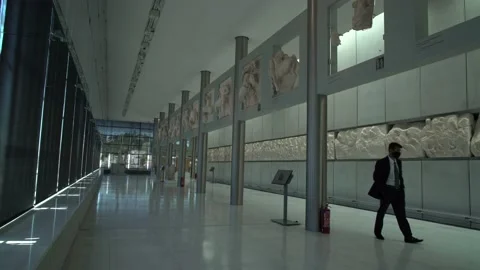 Guard with mask walking at the empty Acropolis Museum during a press visit a Stock Footage 145754332