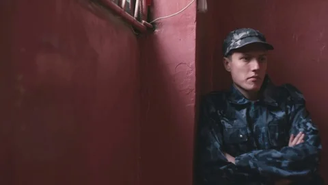 Guard sits by the wall Video stock 76508905