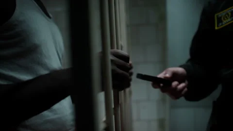 Guard Smuggling Cell Phone to Prisoner Illegary Stock Footage 263254494