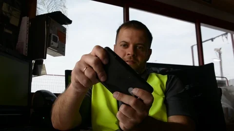 Guard  in uniform plays on smartphone at workplace. Stock-Footage 108541065