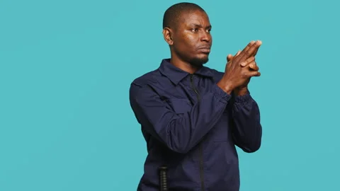Guardian prepared to handle security breaches, doing pistol fingers gesturing Stock Footage 278068955
