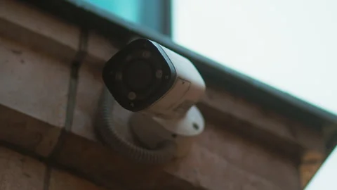 Guardians of heritage: CCTV security cameras oversee the cobblestone streets and Stock Footage 271156997