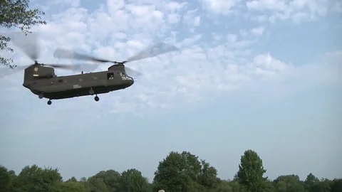 Guards attach sling t o CH-47 helicopter to lift a bridging section - 2014 Stock Footage 103619736