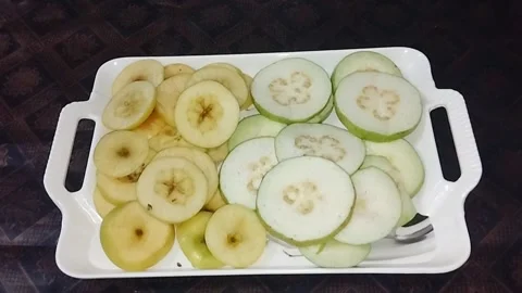 Guava and apple in a plastic dish 動画素材 268853252