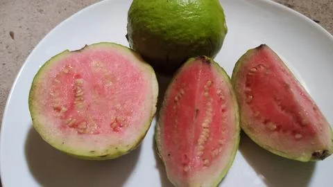 Guava inside is red on a plate Stock Photos