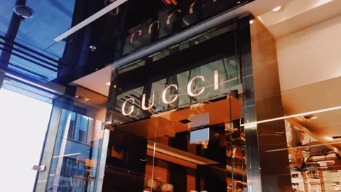 Gucci logo displayed at boutique storefront, fashion and leather goods brand and Stock Footage 139846764