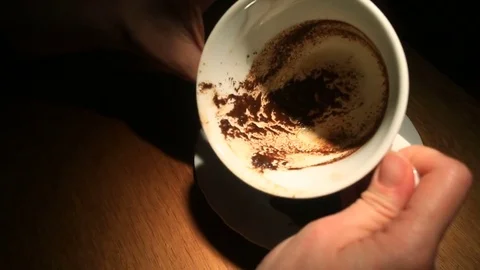 Guessing on the coffee grounds, a female hand holding a coffee mug with coffee Stock Footage 74908554