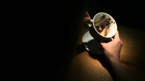 Guessing on the coffee grounds, a female hand holding a coffee mug with coffee Stock Footage 74908596