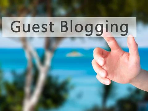 Guest Blogging - Hand pressing a button on blurred background concept on visu Foto stock
