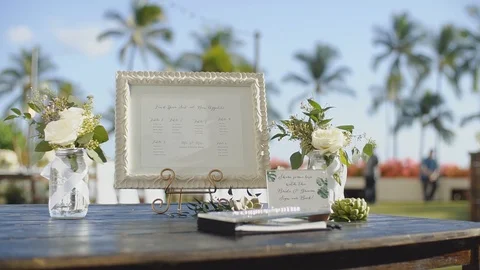 Guest list in white frame between the vases with roses on wedding table,resort Stock Footage 101117053