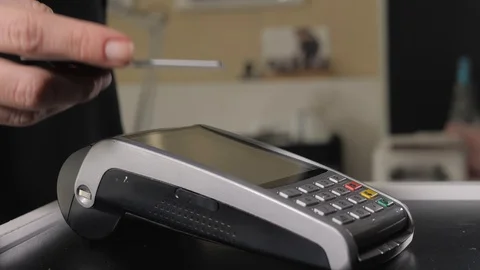 Guest makes card payment at check-in desk of hotel, detail, business woman in Stock Footage 102975411