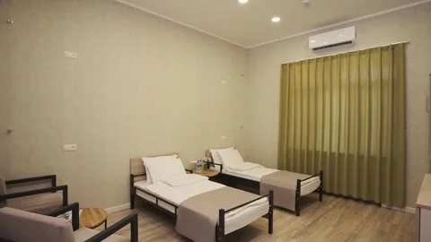 A guest room with two beds in a small cozy hotel Stock Footage 255766885