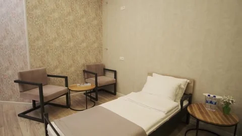 A guest room with two beds in a small cozy hotel Stock Footage 307743716