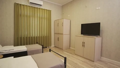 A guest room with two beds in a small cozy hotel Stock Footage 310315133