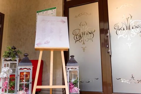 Guest seating plan with decorative elements in festive wedding hall. Stock Photos