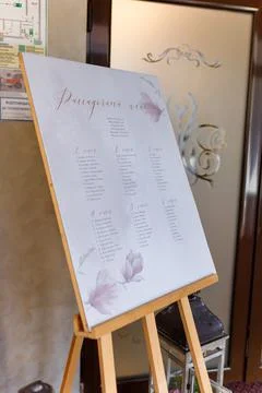 Guest seating plan with decorative elements in festive wedding hall. guests list Stock Photos