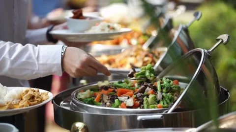 Guest serving fresh vegetables from a buffet catering station Video stock 336231489