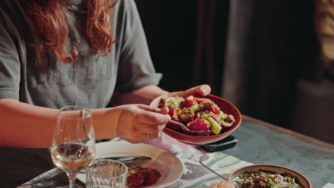 Guest serving a plate of radish and cucumber salad Stock Footage 346745762