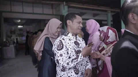 Guest shake hand with the bride after traditional wedding ceremony in Indonesia Stock Footage 204826968