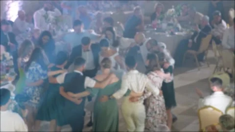 The guests are dancing around them, the bride and groom. Blurred Stock Footage 243679358