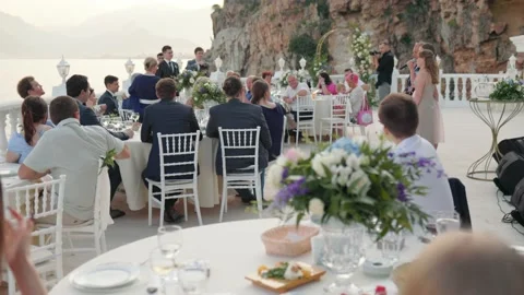 Guests are sitting at the table on beautiful wedding on seaside Stock Footage 201417819