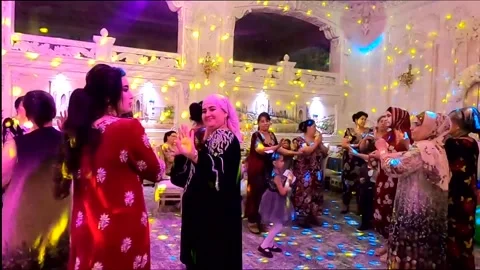 Guests dancing and showing thumbs up at Uzbek family party, Samarkand Stock Footage 336506592