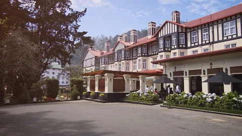 Guests dine in the garden of the Grand Hotel Nuwara Eliya. Stock Footage 79608053