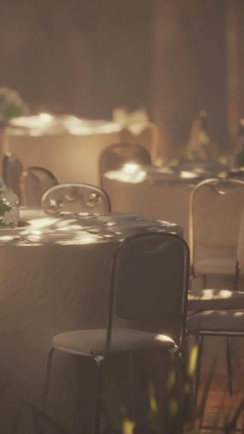 Guests enjoy a meal at tables set in a forest setting during daylight hours Stock Footage 338376577