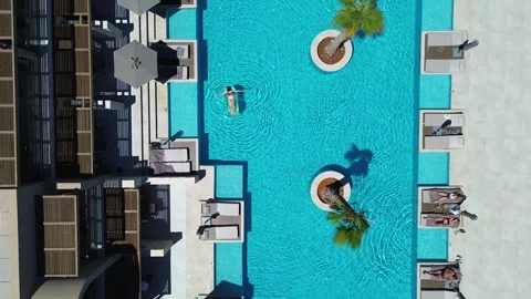 Guests enjoy pool at the resort Stock Footage 342350126