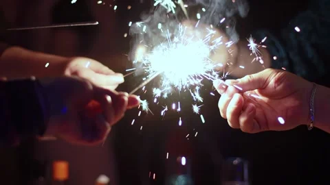 Guests hands hold sparklers in their hands for Christmas and New Year 2025 스톡 동영상 295104189