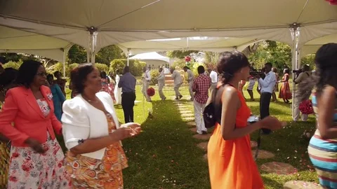 Guests of a middle class wedding party in Nairobi dancing in a big circle Stock Footage 76396003